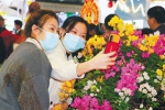 　市民游客在昌江馆展出的三角梅前自拍。 钟玉莹 摄 - 中新网海南频道